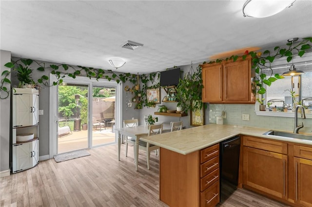 68 Everglade Ave, Warwick, RI 02886 - kitchen featuring light countertops, dishwasher, backsplash, brown cabinets, and a peninsula