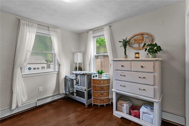 68 Everglade Ave, Warwick, RI 02886 - living area with a baseboard heating unit and dark wood-type flooring