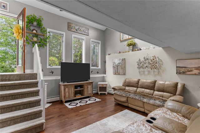 68 Everglade Ave, Warwick, RI 02886 - living room featuring a baseboard radiator, dark wood-style flooring, and stairs