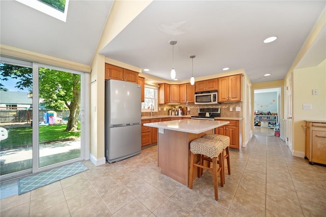 79 Pilgrim Dr, Warwick, RI 02888 - kitchen featuring stainless steel appliances, decorative backsplash, light countertops, a sink, and light tile patterned floors