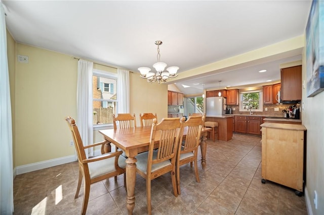 79 Pilgrim Dr, Warwick, RI 02888 - dining room with a chandelier, baseboards, and light tile patterned flooring