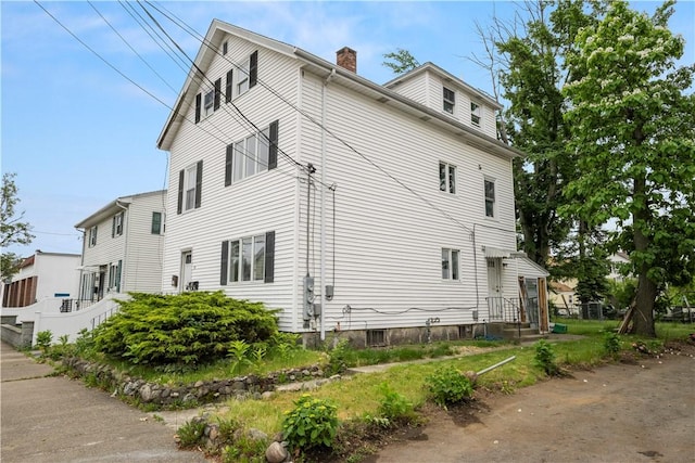 35 Laurel St, Pawtucket, RI 02860 - view of side of property featuring a chimney