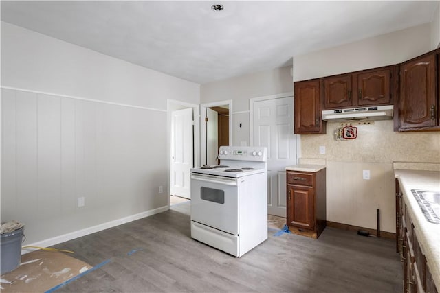 35 Laurel St, Pawtucket, RI 02860 - kitchen with white range with electric stovetop, under cabinet range hood, wood finished floors, light countertops, and baseboards