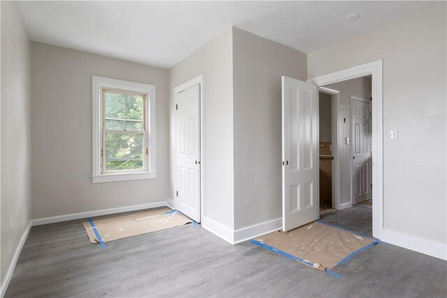 35 Laurel St, Pawtucket, RI 02860 - unfurnished bedroom with baseboards, wood finished floors, and a closet