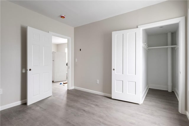 35 Laurel St, Pawtucket, RI 02860 - unfurnished bedroom with freestanding refrigerator, wood finished floors, baseboards, and a closet