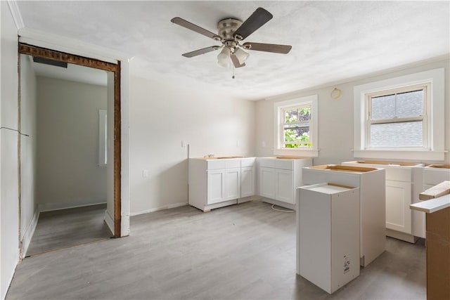 35 Laurel St, Pawtucket, RI 02860 - kitchen with light wood-style floors, ceiling fan, white cabinets, and baseboards