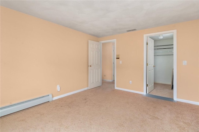 20 Pond Ct Unit A, North Providence, RI 02904 - unfurnished bedroom with a baseboard radiator, carpet floors, baseboards, and a spacious closet