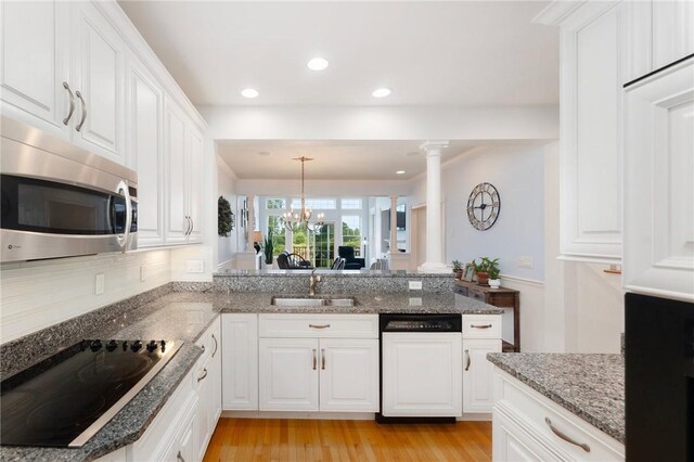 83 Waters Edge St Unit 24, Tiverton, RI 02878 - kitchen with dishwasher, ornate columns, a sink, black electric cooktop, and stainless steel microwave