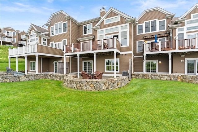 83 Waters Edge St Unit 24, Tiverton, RI 02878 - back of house with a chimney, a lawn, a patio area, and a wooden deck