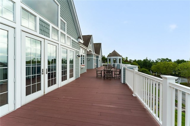 83 Waters Edge St Unit 24, Tiverton, RI 02878 - wooden terrace with outdoor dining space