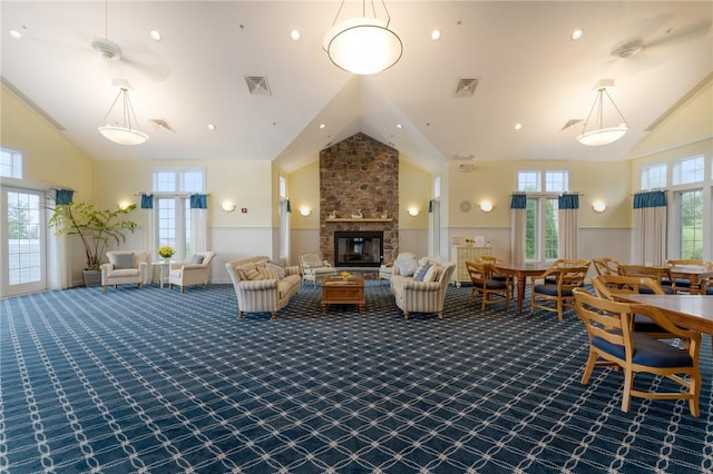 83 Waters Edge St Unit 24, Tiverton, RI 02878 - living area with high vaulted ceiling, a stone fireplace, and dark carpet