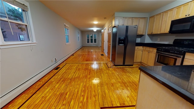 89 Evergreen St, Providence, RI 02906 - kitchen featuring appliances with stainless steel finishes, light wood-style floors, light brown cabinets, dark countertops, and a baseboard heating unit