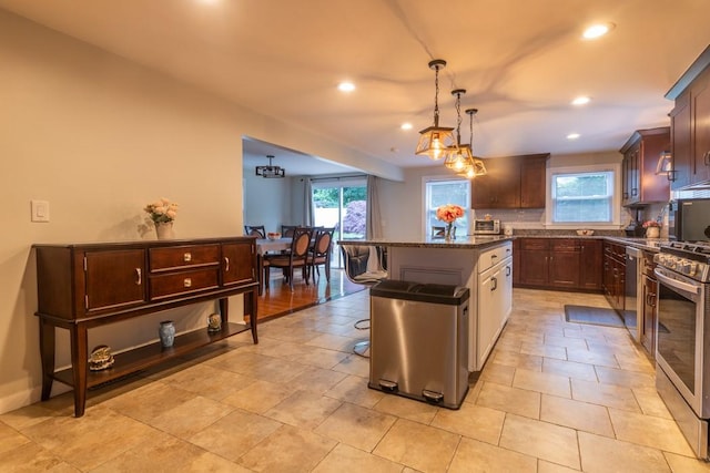 21 Baldwin Rd, Warwick, RI 02886 - kitchen with recessed lighting, a center island, dark stone counters, backsplash, and stainless steel appliances