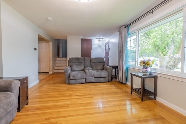 21 Baldwin Rd, Warwick, RI 02886 - living room with plenty of natural light, light wood-style floors, baseboards, and stairway