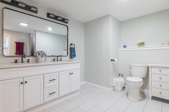 21 Baldwin Rd, Warwick, RI 02886 - full bathroom with double vanity, toilet, baseboards, and tile patterned flooring