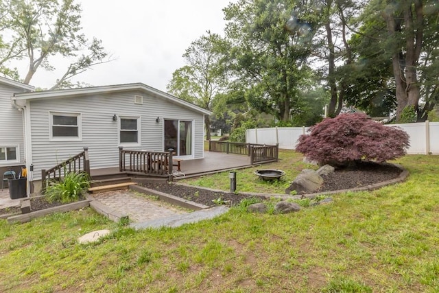 21 Baldwin Rd, Warwick, RI 02886 - rear view of property featuring a wooden deck and an outdoor fire pit