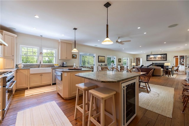 137 Cove Pt E, Charlestown, RI 02813 - kitchen with a kitchen island, wine cooler, appliances with stainless steel finishes, a ceiling fan, and open floor plan