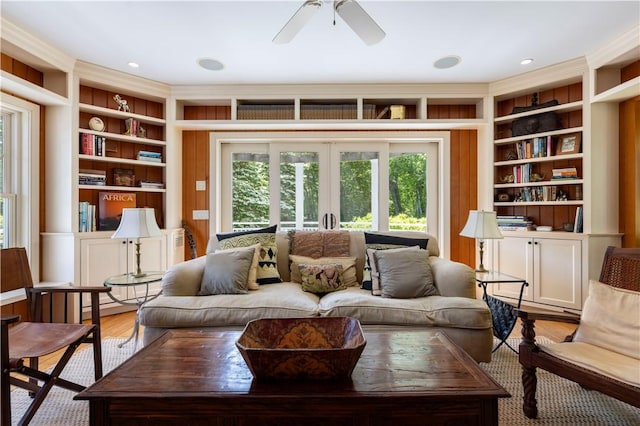 137 Cove Pt E, Charlestown, RI 02813 - living room featuring built in shelves, a ceiling fan, and wood finished floors