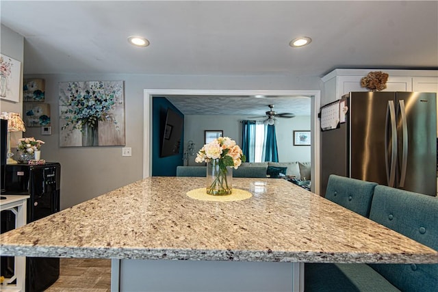 34 Zambarano Ave, North Providence, RI 02911 - kitchen with light stone countertops, freestanding refrigerator, white cabinets, a ceiling fan, and recessed lighting