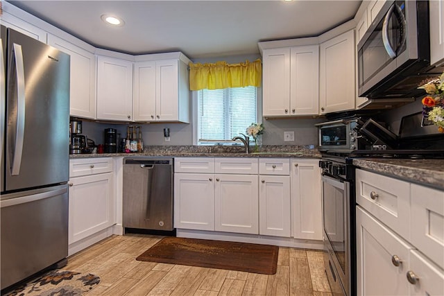 34 Zambarano Ave, North Providence, RI 02911 - kitchen featuring stainless steel appliances, white cabinetry, light wood-style flooring, recessed lighting, and dark stone countertops