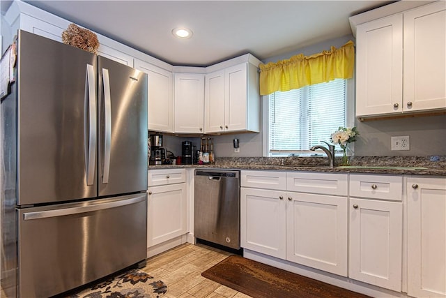 34 Zambarano Ave, North Providence, RI 02911 - kitchen featuring appliances with stainless steel finishes, white cabinetry, light wood-style floors, dark stone counters, and recessed lighting