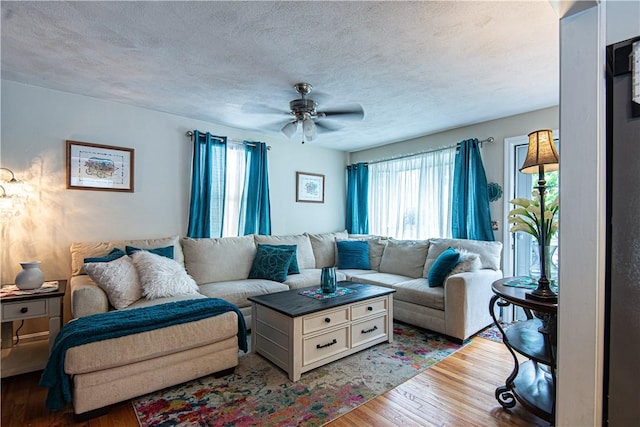 34 Zambarano Ave, North Providence, RI 02911 - living area featuring plenty of natural light, light wood-type flooring, a ceiling fan, and a textured ceiling
