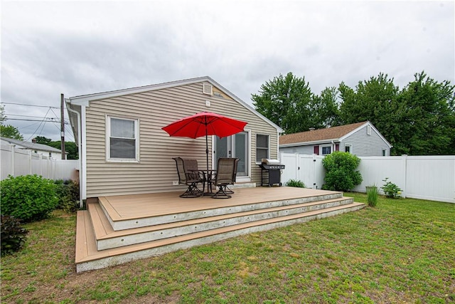 34 Zambarano Ave, North Providence, RI 02911 - rear view of house with a fenced backyard, a wooden deck, and outdoor dining space