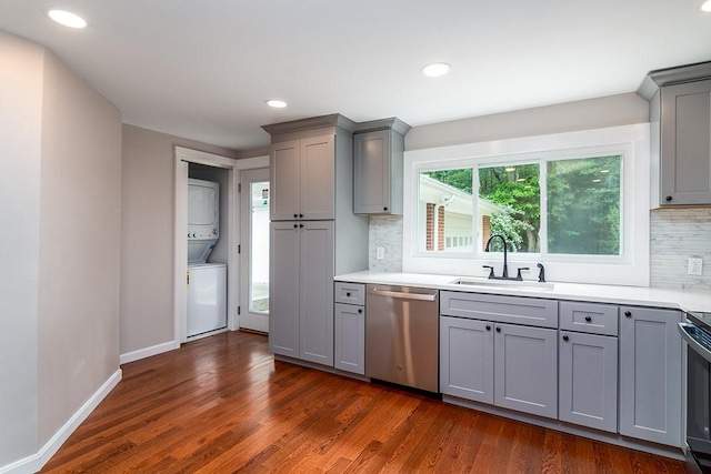 137 Rocky Hill Rd, Scituate, RI 02857 - kitchen featuring dishwasher, gray cabinets, stacked washer and clothes dryer, dark wood-type flooring, and recessed lighting