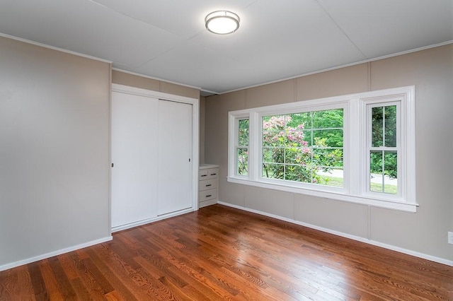 137 Rocky Hill Rd, Scituate, RI 02857 - unfurnished bedroom with wood finished floors, a closet, and crown molding