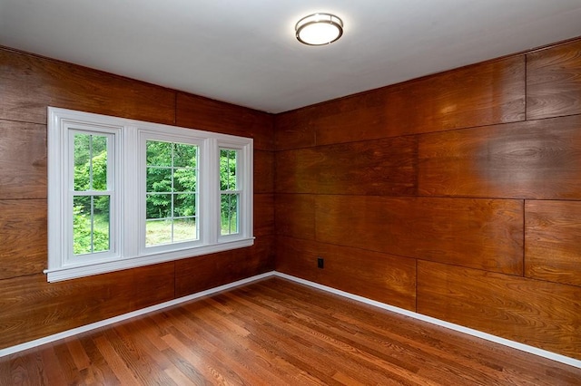 137 Rocky Hill Rd, Scituate, RI 02857 - empty room featuring wood finished floors, plenty of natural light, and wooden walls