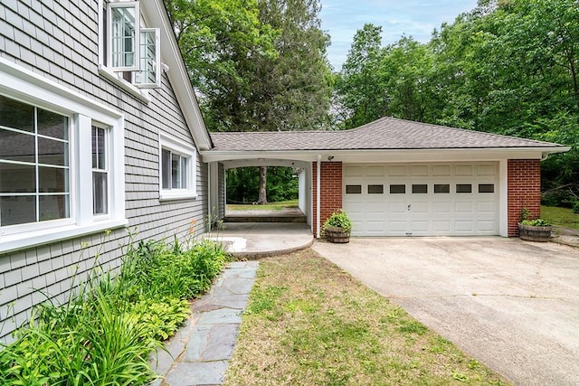 137 Rocky Hill Rd, Scituate, RI 02857 - view of home's exterior featuring driveway, brick siding, and an attached garage