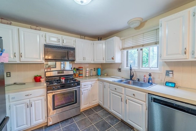 7 Tamarac Dr Unit F, Smithfield, RI 02828 - kitchen featuring stainless steel appliances, white cabinets, dark tile patterned flooring, backsplash, and light countertops