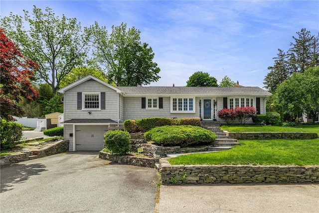 64 Dean St, Cranston, RI 02920 - ranch-style house featuring driveway, an attached garage, and a front yard