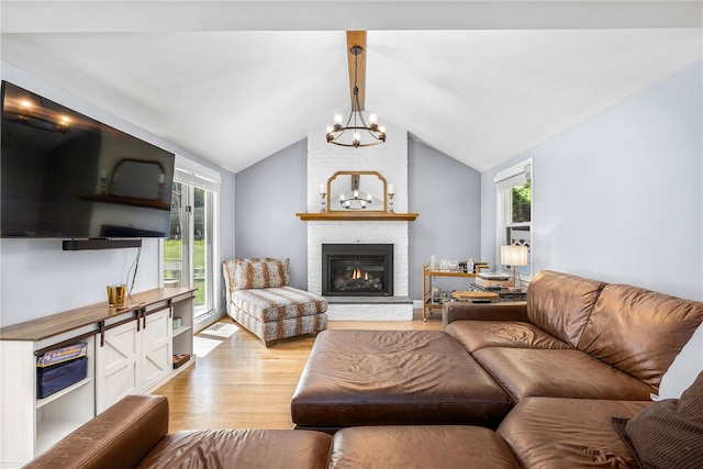 64 Dean St, Cranston, RI 02920 - living area with light wood-type flooring, a brick fireplace, and a chandelier