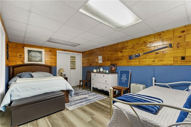 447 Stafford Rd Unit C3, Tiverton, RI 02878 - bedroom featuring wood walls, a drop ceiling, wood finished floors, and a closet