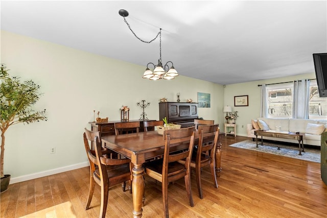 447 Stafford Rd Unit C3, Tiverton, RI 02878 - dining area with light wood-type flooring and a chandelier