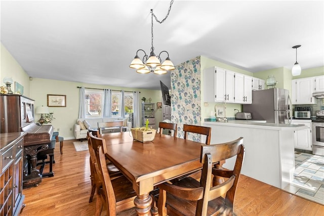 447 Stafford Rd Unit C3, Tiverton, RI 02878 - dining area with a chandelier and light wood-style flooring