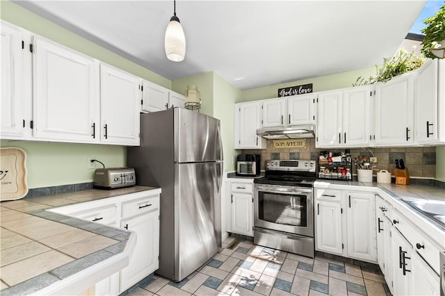 447 Stafford Rd Unit C3, Tiverton, RI 02878 - kitchen with stainless steel appliances, tile countertops, under cabinet range hood, and white cabinets