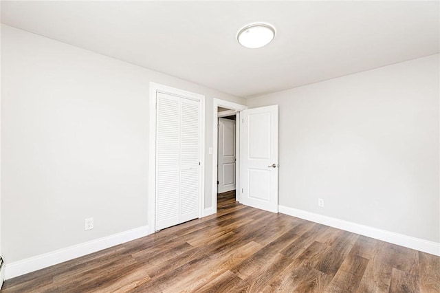 65 Harrop Ave, Warwick, RI 02886 - unfurnished bedroom featuring wood finished floors, a closet, and a baseboard radiator