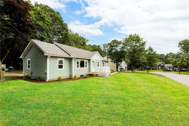 65 Harrop Ave, Warwick, RI 02886 - view of front of property featuring a front yard, a deck, and a shingled roof