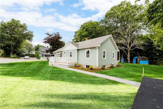 65 Harrop Ave, Warwick, RI 02886 - view of side of home with a storage unit, a lawn, and a chimney