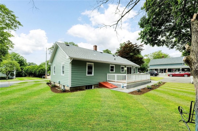 65 Harrop Ave, Warwick, RI 02886 - back of house with a wooden deck, a lawn, and a chimney