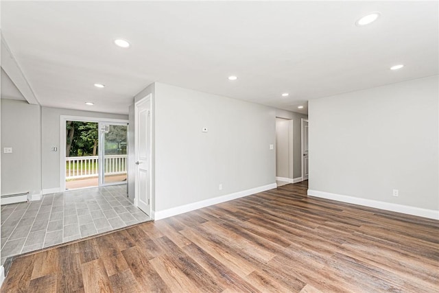 65 Harrop Ave, Warwick, RI 02886 - unfurnished room with baseboard heating, wood finished floors, and recessed lighting