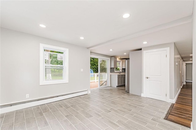65 Harrop Ave, Warwick, RI 02886 - unfurnished living room with a baseboard heating unit, recessed lighting, and light wood-style flooring