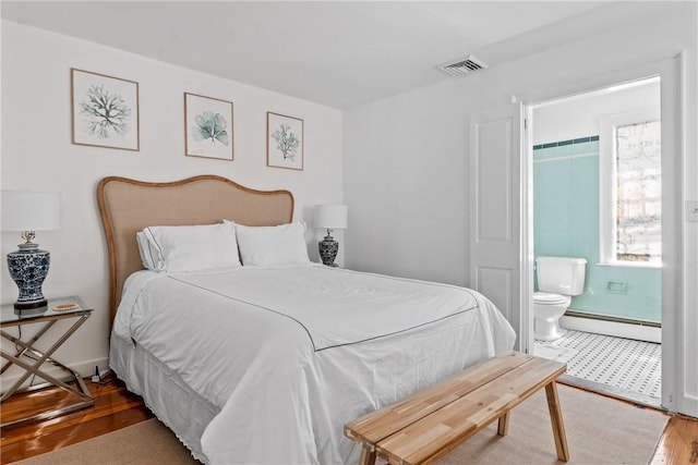 35 Second St, Newport, RI 02840 - bedroom featuring baseboard heating, wood finished floors, and connected bathroom