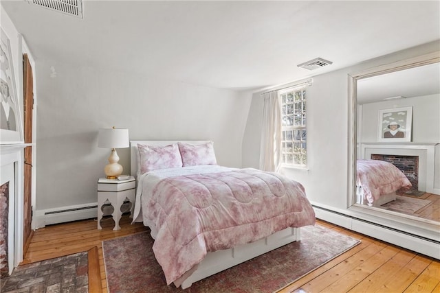 35 Second St, Newport, RI 02840 - bedroom with a fireplace, a baseboard radiator, and wood-type flooring