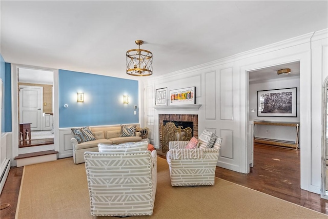 35 Second St, Newport, RI 02840 - living room with a decorative wall, wood finished floors, a chandelier, a fireplace, and a wainscoted wall