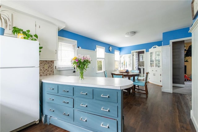 40 Highland St, Pawtucket, RI 02860 - kitchen with freestanding refrigerator, blue cabinetry, light countertops, a peninsula, and dark wood-type flooring
