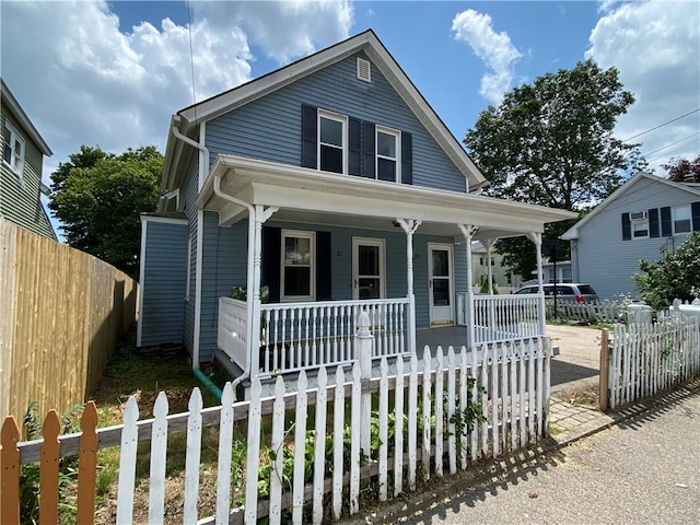 25 Eddy St, West Warwick, RI 02893 - view of front facade featuring covered porch and a fenced front yard