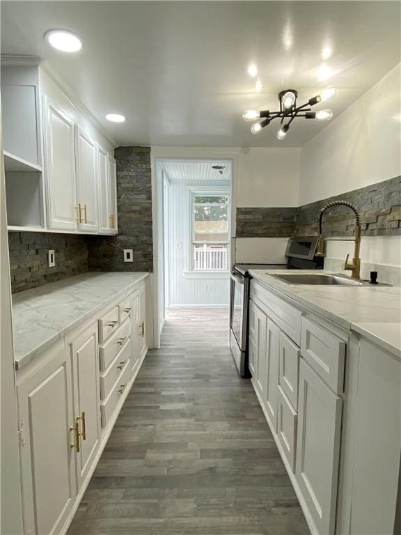 25 Eddy St, West Warwick, RI 02893 - kitchen with stainless steel range with electric stovetop, white cabinetry, open shelves, and decorative backsplash